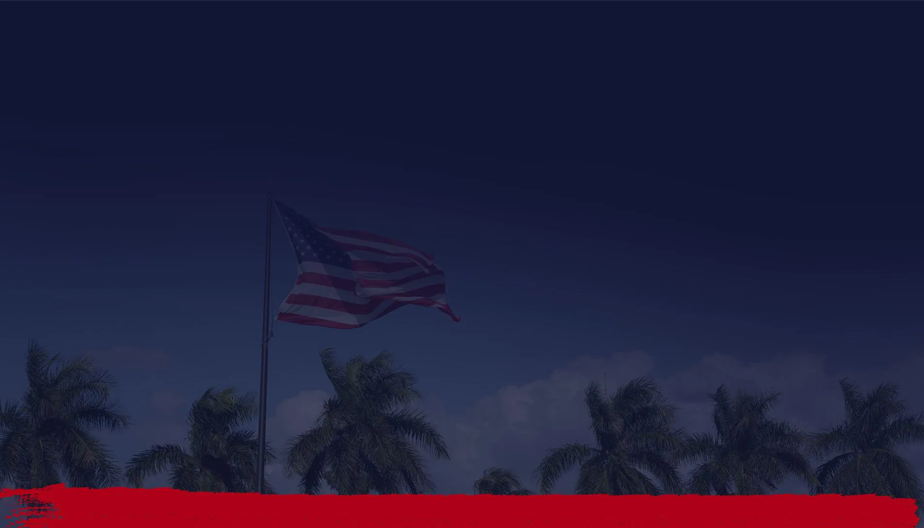 American flag waving above palm trees under blue skies in Jacksonville, Florida.