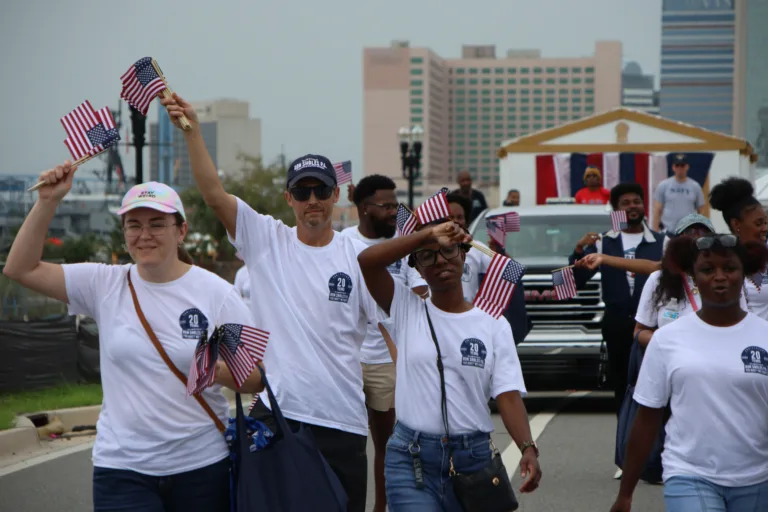 Ron Sholes staff walking in Jacksonville Veterans Day Parade, personal injury lawyers.