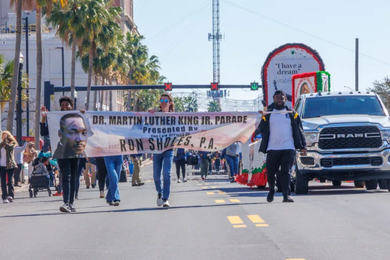 Ron Sholes law firm banner at Jacksonville Martin Luther King Day Parade, title sponsor.