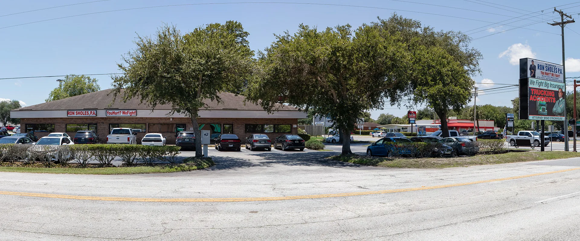 Front view of the Law Offices of Ron Sholes, P.A. in Orange Park Florida on Blanding Blvd showing the digital billboard for trucking accident representation.